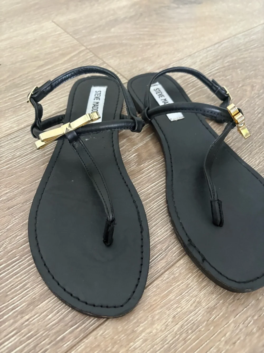 Steve Madden Black T-Strap Sandals with Gold Bow Accent